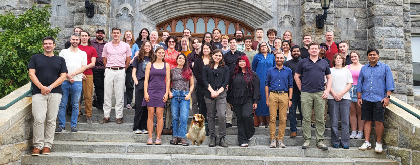 Members of Astronomy & Physics standing on stairs in front of a building