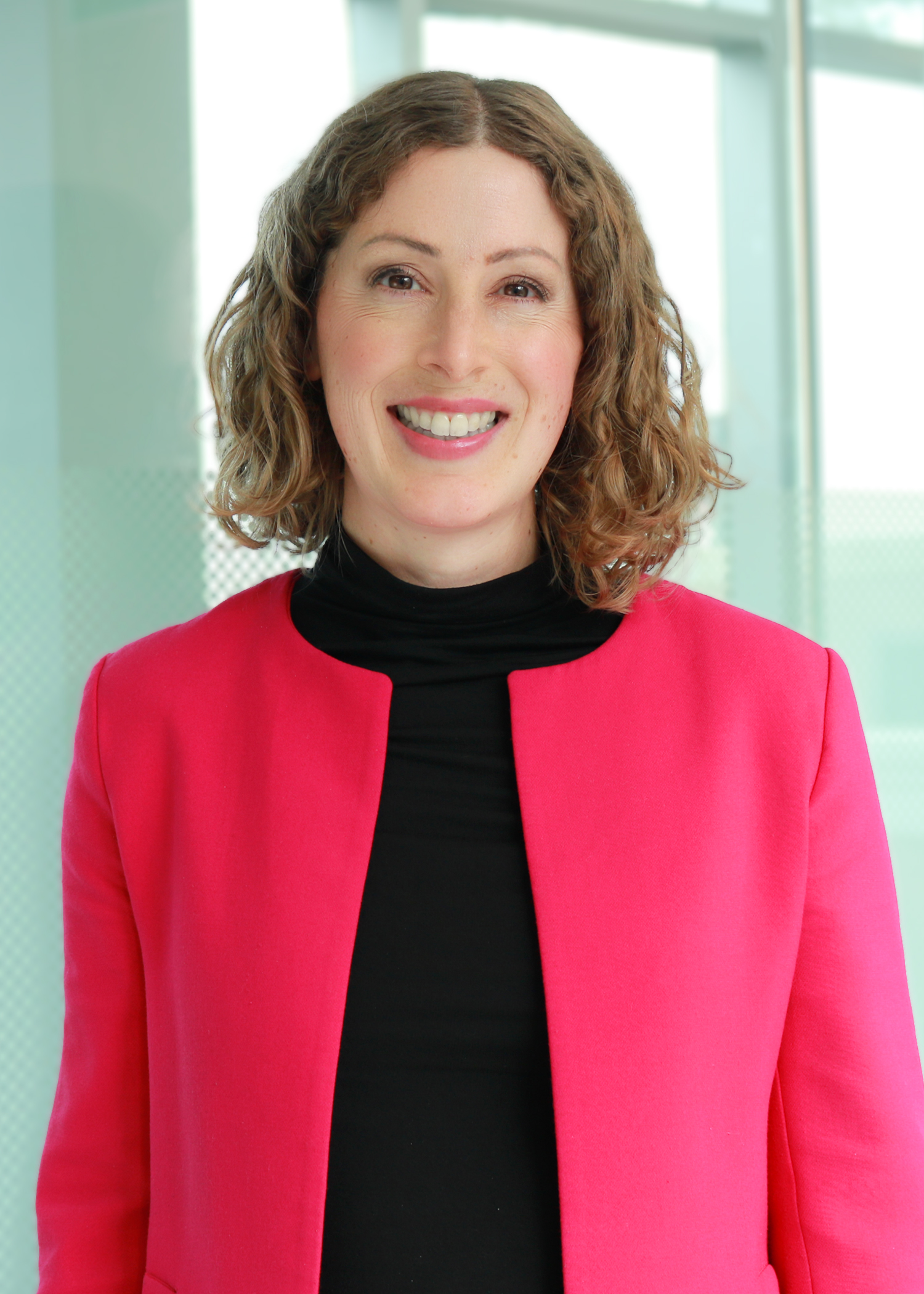 Lauren is a white woman with chin length curly brown hair