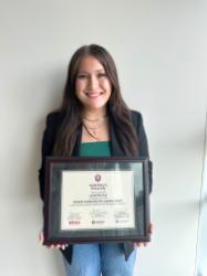 Lydia holding her award