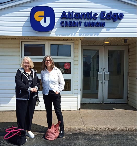 Atlantic edge credit union building with two people standing out front